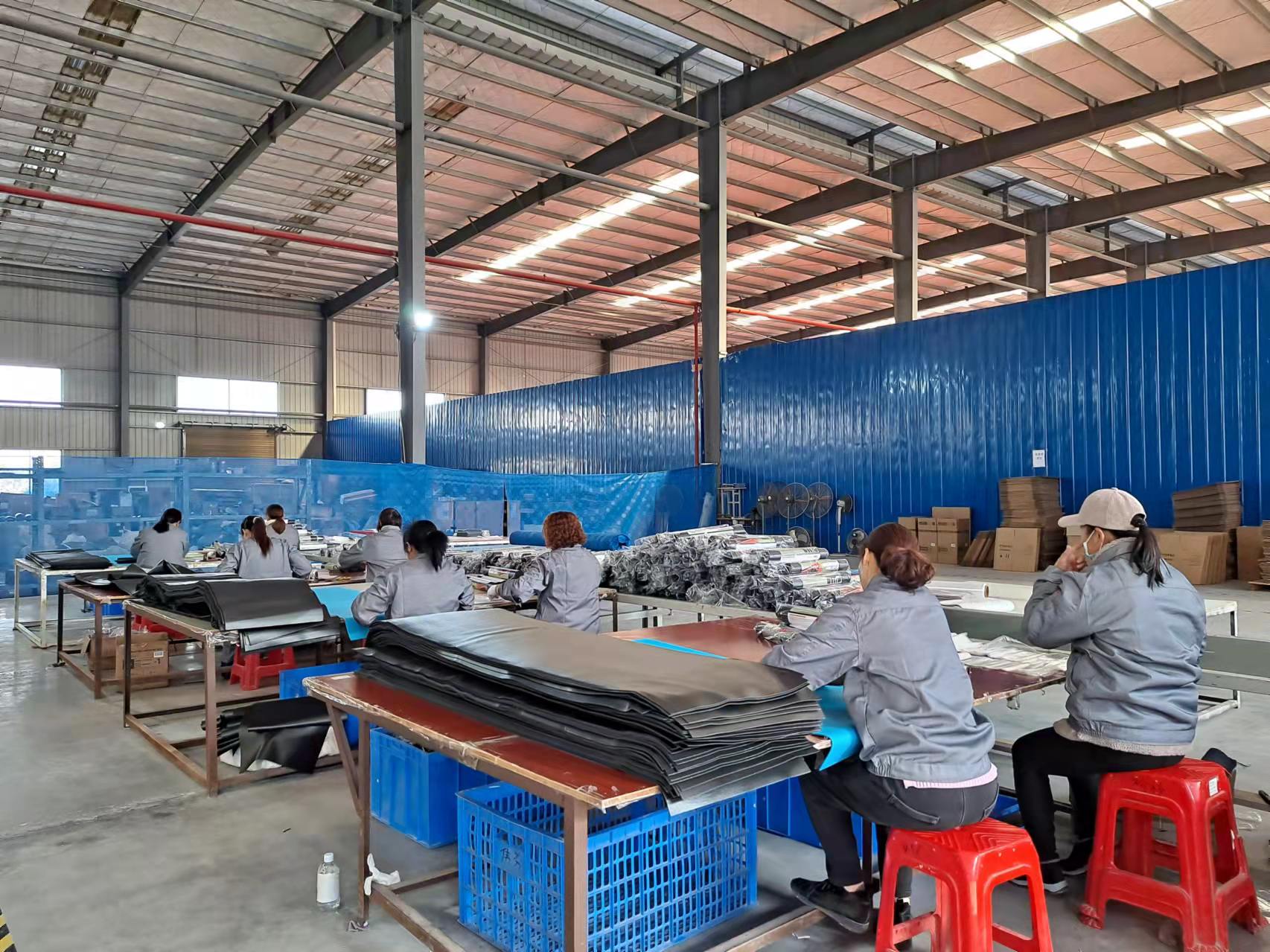 AICO Yoga factory workers assembling yoga and fitness products for OEM and ODM manufacturing.