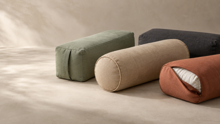 Custom yoga bolsters in rectangular and cylindrical shapes with removable fabric covers for private label sourcing.